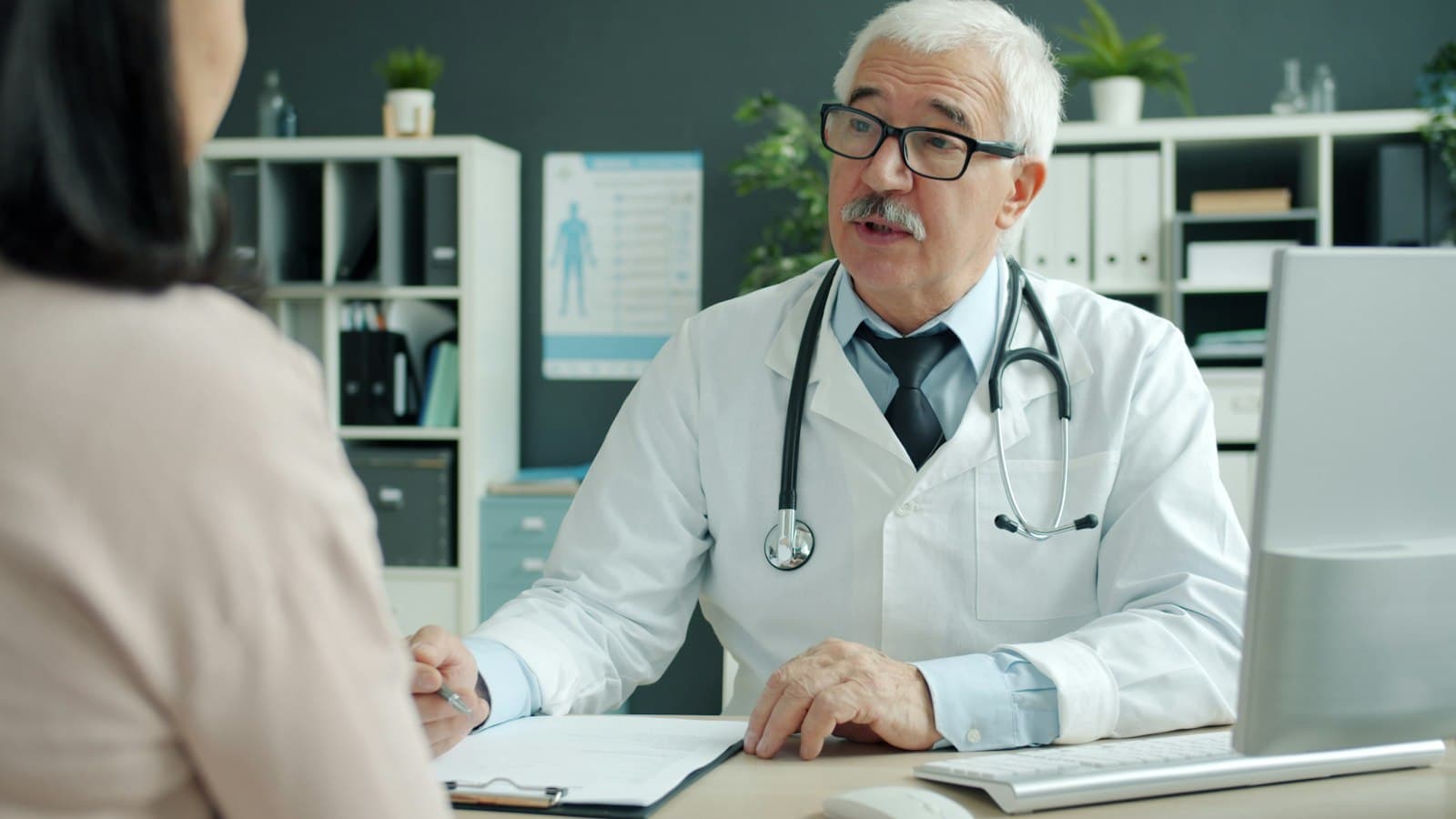 A doctor talking with a patient in a consulting room